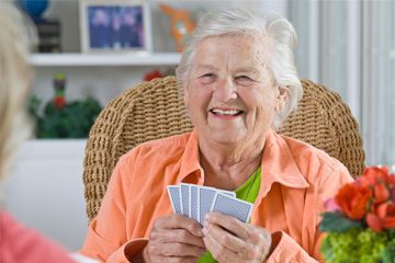 smiling lady playing cards