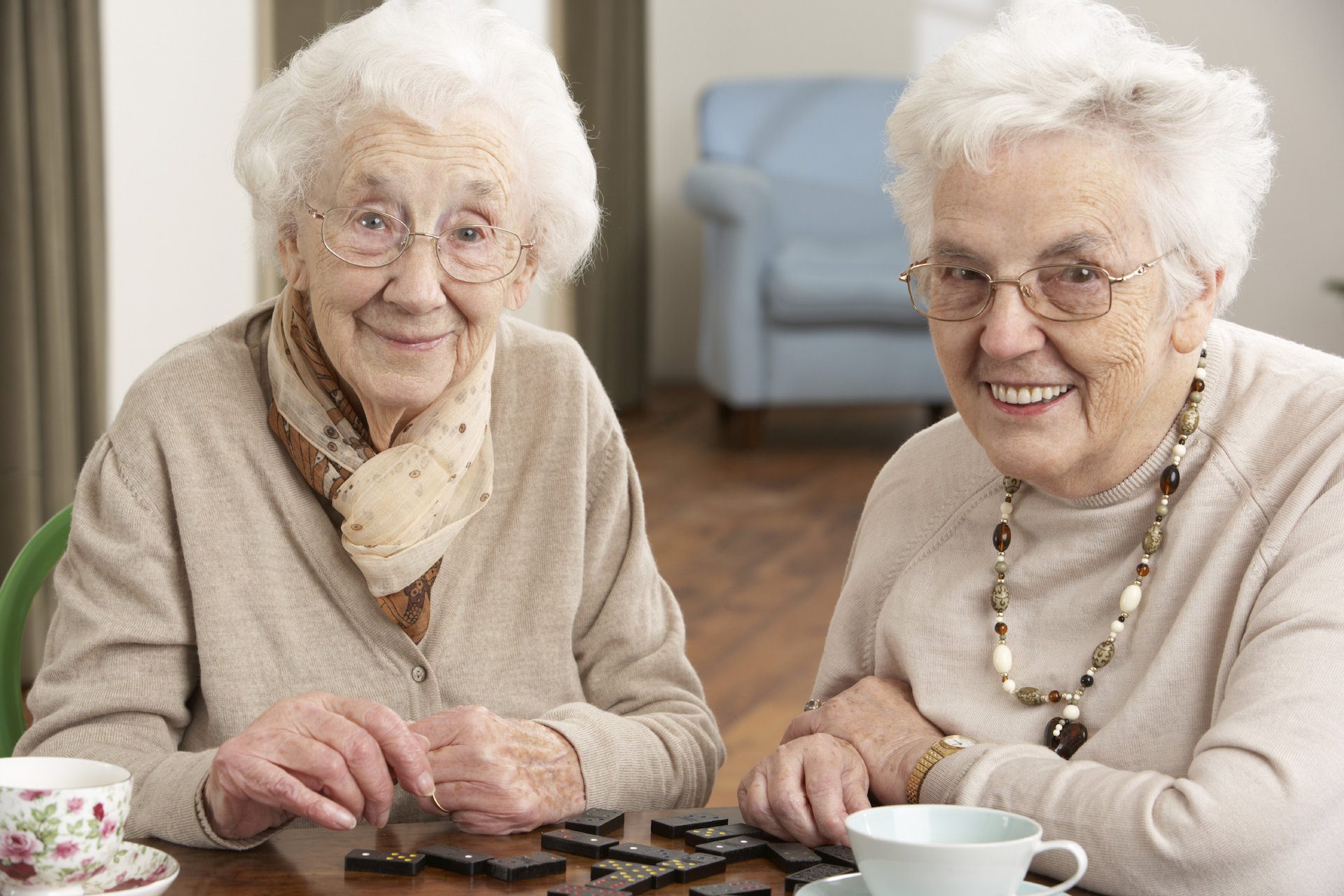 two senior women playing dominos