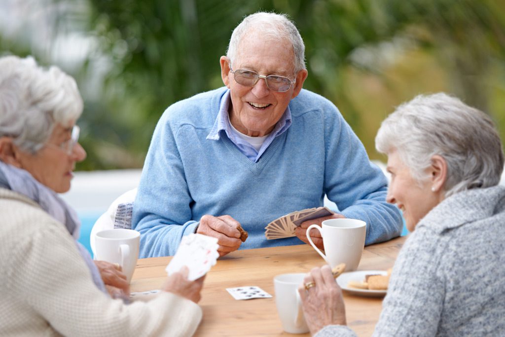 three seniors playing cards