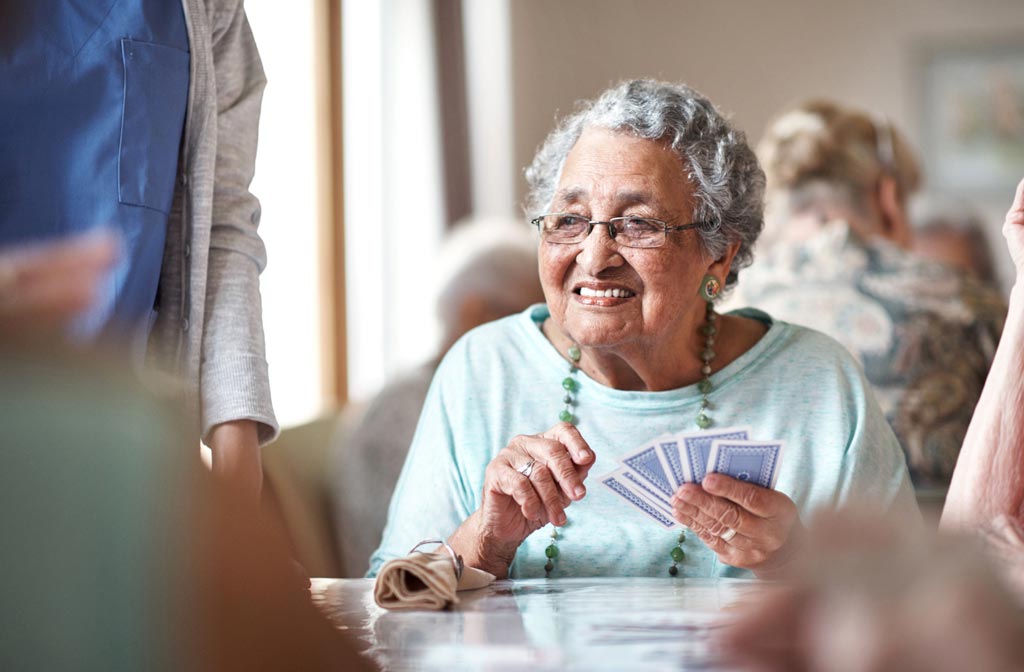 a senior woman playing cards